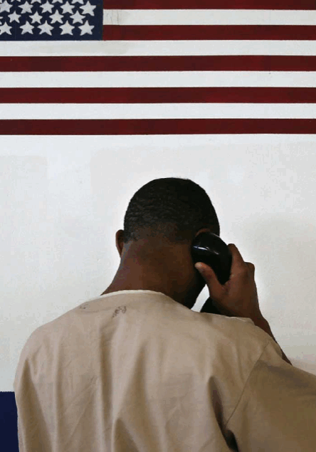 man making call to family from prison