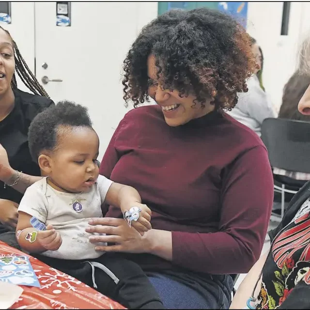 From right to left, Jen­nifer Spinello, of Tor­ring­ton, watches her step­daugh­ter Mor­gan Leach with her son Hunter, 10 months, and her sis­ter Jai­dyn Gib­son, of Tor­ring­ton.